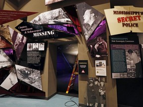 In this Nov. 10, 2017 image, the story of the three civil rights workers who were kidnapped, murdered and had their bodies hidden by the Ku Klux Klan, is told as is the establishing of the the state funded Sovereignty Commission, an agency that spied on its citizens in the "I Question America," gallery in the Mississippi Civil Rights Museum in Jackson, Miss., museum. This facility is adjacent to the newly built Museum of Mississippi History, that documents the state's rich history and the diversity of its people. Work crews and archivists are putting the final touches on the two museums set to open Dec. 9.
