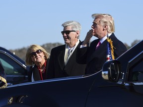 President Donald Trump, right, standing with Mississippi Gov. Phil Bryant, center, blows a kiss to the crowd after arriving on Air Force One at Jackson-Medgar Wiley Evers International Airport in Jackson, Miss., Saturday, Dec. 9, 2017. Trump is speaking at the opening of the Mississippi Civil Rights Museum in Jackson.