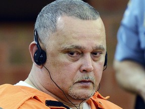 In this July 22, 2011, file photo, Pedro Miranda listens to a translation of a family victim impact statement during his sentencing at Superior Court, in Hartford, Conn., for the 1988 murder of Carmen Lopez.