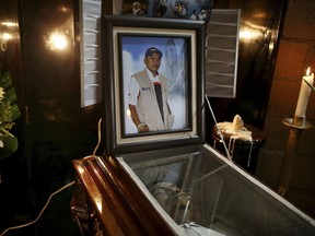 A picture of slain journalist Gumaro Perez stands on his open casket during a wake inside his mother's home in Acayucan, Veracruz state, Mexico, Wednesday, Dec. 20, 2017. The 34-year-old Perez was shot to death Tuesday while at a Christmas party at his son's school in Acayucan.