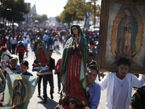 Pilgrims carry images of Our Lady of Guadalupe toward the Basilica of the Virgin of Guadalupe in Mexico City, Monday, Dec. 11, 2017. Hundreds of thousands of Mexicans are making the pilgrimage to the shrine in anticipation of the Catholic icon's feast day on Dec. 12.