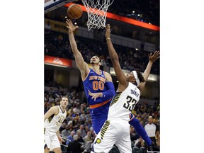 New York Knicks center Enes Kanter (00) shoots under Indiana Pacers center Myles Turner (33) during the first half of an NBA basketball game in Indianapolis, Monday, Dec. 4, 2017.