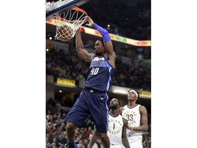 Dallas Mavericks forward Harrison Barnes dunks in front of Indiana Pacers center Myles Turner (33) and guard Lance Stephenson (1) during the first half of an NBA basketball game in Indianapolis, Wednesday, Dec. 27, 2017.