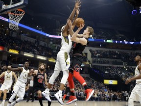 Chicago Bulls forward Lauri Markkanen (24) shoots over Indiana Pacers center Myles Turner during the first half of an NBA basketball game in Indianapolis, Wednesday, Dec. 6, 2017.