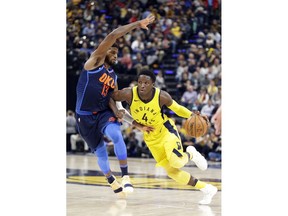 Indiana Pacers guard Victor Oladipo (4) drives on Oklahoma City Thunder forward Paul George (13) during the second half of an NBA basketball game in Indianapolis, Wednesday, Dec. 13, 2017. The Thunder defeated the Pacers 100-95.
