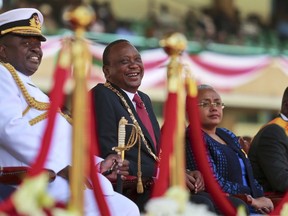 Kenya's President Uhuru Kenyatta, center, his wife Margaret, center-right, and Deputy President William Ruto, right, attend a ceremony to mark Jamhuri (Republic) Day at Kasarani stadium on the outskirts of Nairobi, Kenya, Tuesday, Dec. 12, 2017. Jamhuri Day marks the date when the country gained independence from the United Kingdom in 1963.
