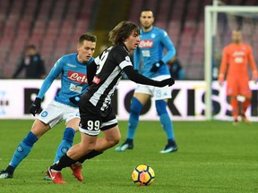 Udinese's Andrija Balic, right, and Napoli's Piotr Zielinski fight for the ball during an Italian Cup soccer match between Napoli and Udinese, at the San Paolo stadium in Naples, Tuesday, Jan. 19, 2017.