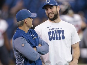 Indianapolis Colts head coach Chuck Pagano talks with Andrew Luck before an NFL football game against the Houston Texans, Sunday, Dec. 31, 2017, in Indianapolis.