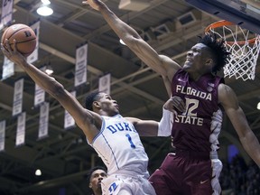 Duke's Trevon Duval (1) attempts a shot over Florida State's Ike Obiagu (12) during the first half of an NCAA college basketball game in Durham, N.C., Saturday, Dec. 30, 2017.