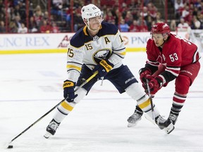 Buffalo Sabres' Jack Eichel (15) handles the puck ahead of Carolina Hurricanes' Jeff Skinner (53) during the first period of an NHL hockey game in Raleigh, N.C., Saturday, Dec. 23, 2017.
