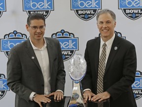 Wake Forest head coach Dave Clawson, right, and Texas A&M interim head coach Jeff Banks, left, pose with the trophy during media day for the Belk Bowl NCAA college football game in Charlotte, N.C., Thursday, Dec. 28, 2017.