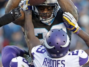 Carolina Panthers' Jonathan Stewart (28) dives over the goal line against Minnesota Vikings' Xavier Rhodes (29) for a touchdown during the second half of an NFL football game in Charlotte, N.C., Sunday, Dec. 10, 2017.