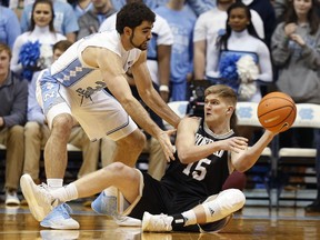 Wofford guard Trevor Stumpe (15) looks to make a pass under pressure from North Carolina forward Luke Maye during the first half of an NCAA college basketball game in Chapel Hill, N.C., Wednesday, Dec. 20, 2017.