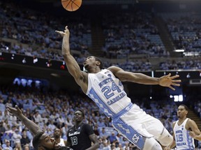 North Carolina's Kenny Williams (24) drives to the basket while Tulane's Jordan Cornish (0) defends during the first half of an NCAA college basketball game in Chapel Hill, N.C., Sunday, Dec. 3, 2017.
