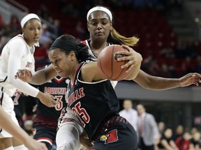 Louisville's Asia Durr (25) drives around North Carolina State's Kiara Leslie during the first half of an NCAA college basketball game in Raleigh, N.C., Sunday, Dec. 31, 2017.