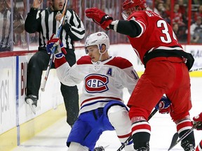 Montreal Canadiens' Brendan Gallagher (11) collides with Carolina Hurricanes' Phillip Di Giuseppe (34) during the first period of an NHL hockey game, Wednesday, Dec. 27, 2017, in Raleigh, N.C.