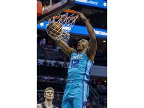 Charlotte Hornets center Dwight Howard dunks as Chicago Bulls forward Lauri Markkanen of Finland looks on in the first half of an NBA basketball game in Charlotte, N.C., Friday, Dec. 8, 2017.