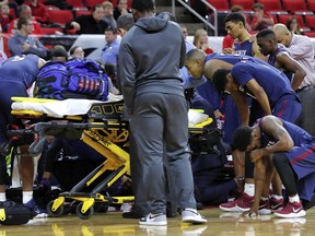 South Carolina State players react as Ty Solomon is attended to after he was injured during the first half of an NCAA college basketball game against North Carolina State at PNC Arena in Raleigh, N.C., Saturday, Dec. 2, 2017.