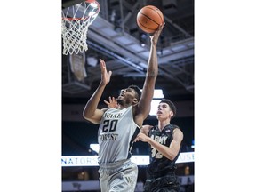 Wake Forest forward Terrence Thompson (20) drives to the basket under defense from Army forward Alex King (32) during an NCAA college basketball game, Friday, Dec. 8, 2017 in Winston-Salem, N.C.