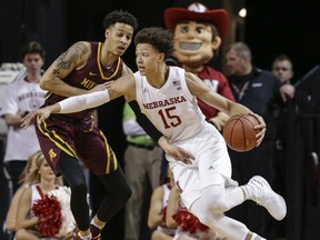 Nebraska's Isaiah Roby (15) tries to drive around Minnesota's Amir Coffey during the first half of an NCAA college basketball game in Lincoln, Neb., Tuesday, Dec. 5, 2017.