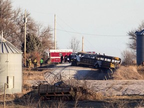 Investigators work the scene of a school bus fire that killed at least two Tuesday, Dec. 12, 2017, near Oakland, Iowa. The bus was engulfed in flames when firefighters arrived.