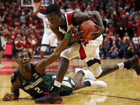 Rutgers guard Issa Thiam grabs a loose ball in front of Michigan State forward Jaren Jackson Jr. (2) during the first half of an NCAA college basketball game Tuesday, Dec. 5, 2017, in Piscataway, N.J.