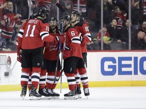 New Jersey Devils players celebrate a goal by center Brian Boyle (11) during the first period of an NHL hockey game against the Chicago Blackhawks, Saturday, Dec. 23, 2017, in Newark, N.J.