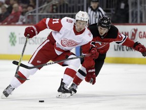 Detroit Red Wings center Dylan Larkin (71) skates against New Jersey Devils center Nico Hischier (13), of Switzerland, during the first period of an NHL hockey game Wednesday, Dec. 27, 2017, in Newark, N.J.