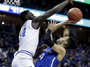 Creighton guard Ronnie Harrell Jr. (4) goes up to shoot against Seton Hall forward Ismael Sanogo (14) during the first half of an NCAA college basketball game, Thursday, Dec. 28, 2017, in Newark, N.J.