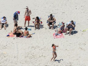 FiLE - In this Sunday, July 2, 2017 file photo, New Jersey Gov. Chris Christie, right, uses the beach with his family and friends at the governor's summer house at Island Beach State Park in New Jersey. New Jersey Gov.-elect Phil Murphy is getting some pushback for posing for photos on Thursday, Dec. 14, 2017, next to a cardboard cutout of Christie lounging on a beach last summer. Christie came under intense criticism for using the beach closed to the public over the Fourth of July weekend due to a government shutdown.