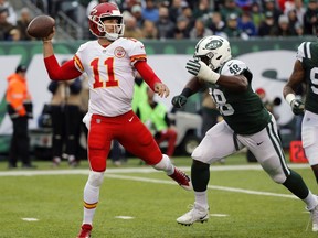 Kansas City Chiefs quarterback Alex Smith, left, throws during the first half of an NFL football game against the New York Jets, Sunday, Dec. 3, 2017, in East Rutherford, N.J.