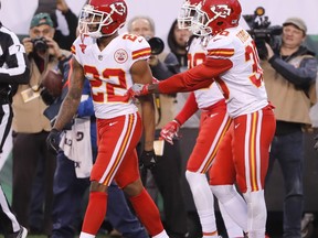 Teammates of Kansas City Chiefs' Marcus Peters, left, try to prevent him from leaving the field after a penalty during the second half of the team's NFL football game against the New York Jets, Sunday, Dec. 3, 2017, in East Rutherford, N.J.