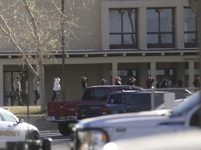 Students are led out of Aztec High School after a shooting Thursday, Dec. 7, 2017, in Aztec, N.M. The school is in the Four Corners region and is near the Navajo Nation.
