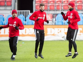 Toronto FC midfielder Michael Bradley, right, defender Drew Moor, centre, and defender Jason Hernandez warm up during practice ahead of the MLS Cup finals against the Seattle Sounders in Toronto on Friday, December 8, 2017.
