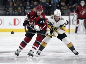 Arizona Coyotes defenseman Oliver Ekman-Larsson (23) and Vegas Golden Knights center Jonathan Marchessault chase the puck during the first period of an NHL hockey game, Sunday, Dec. 3, 2017, in Las Vegas.