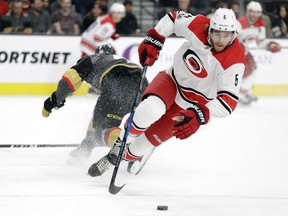Carolina Hurricanes defenseman Noah Hanifin (5) skates past Vegas Golden Knights right wing Pierre-Edouard Bellemare during the first period of an NHL hockey game Tuesday, Dec. 12, 2017, in Las Vegas.