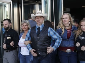 From left, Ryan Payne, Jeanette Finicum, widow of Robert "LaVoy" Finicum, Ryan Bundy, Angela Bundy, wife of Ryan Bundy and Jamie Bundy, daughter of Ryan Bundy, walk out of a federal courthouse Wednesday, Dec. 20, 2017, in Las Vegas. Chief U.S. District Judge Gloria Navarro declared a mistrial Wednesday in the case against Cliven Bundy, his sons Ryan and Ammon Bundy and self-styled Montana militia leader Ryan Payne.