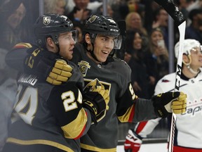Vegas Golden Knights left wing Tomas Nosek, center, celebrates after center Oscar Lindberg, left, scored against the Washington Capitals during the first period of an NHL hockey game Saturday, Dec. 23, 2017, in Las Vegas.