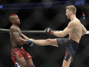 Dan Hooker, right, fights Marc Diakiese in a lightweight mixed martial arts bout at UFC 219, Saturday, Dec. 30, 2017, in Las Vegas.