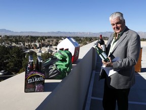 Clark County Commission Chairman Steve Sisolak looks over alcohol in glass bottles before a news conference on New Year's Eve security at Metro Police Headquarters in Las Vegas Wednesday, Dec. 27, 2017. Glass bottles, backpacks and coolers are not permitted on The Strip on New Year's Eve, police said.