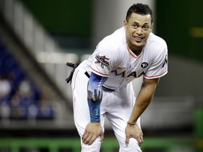 FILE - In this Aug. 14, 2017, file photo, Miami Marlins' Giancarlo Stanton stands on the field during a baseball game against the San Francisco Giants in Miami.  A person familiar with the negotiations says the New York Yankees and Miami Marlins are working on a trade that would send slugger Giancarlo Stanton to New York and infielder Starlin Castro to Miami.  The person spoke to The Associated Press on condition of anonymity Saturday, Dec. 9, 2017, because no agreement has been completed.