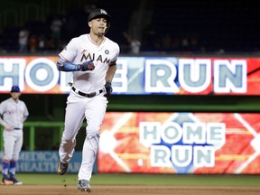 FILE - In this Sept. 18, 2017, file photo, Miami Marlins' Giancarlo Stanton runs the bases after hitting a three-run home run during the fourth inning of a baseball game against the New York Mets in Miami.  A person familiar with the negotiations says the New York Yankees and Miami Marlins are working on a trade that would send slugger Giancarlo Stanton to New York and infielder Starlin Castro to Miami.  The person spoke to The Associated Press on condition of anonymity Saturday, Dec. 9, 2017, because no agreement has been completed.
