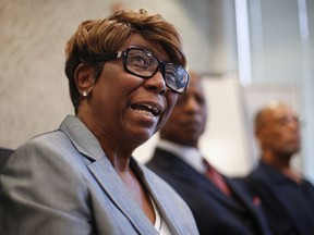 FILE - In this Aug. 23, 2017, file photo, Barbara Butler, accompanied by her husband Phillip, speaks during a news conference at their attorney's office in Washington. Four decades after a Catholic priest who was once a member of the Ku Klux Klan burned a cross on the couple's lawn, he finally wrote them an apology. The Rev. William Aitcheson told Philip and Barbara Butler he was "blinded by hate and ignorance" when he targeted them in 1977 at their home in College Park, Maryland.