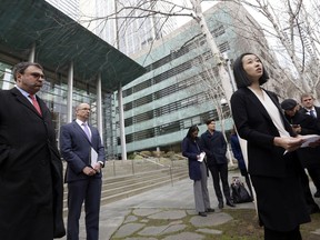 FILE - In this Thursday, Dec. 21, 2017 file photo, Mariko Hirose, right, a litigation director at the Urban Justice Center, speaks to reporters accompanied by Mark Hetfield, president & CEO of HIAS, left, and Rabbi Will Berkowitz, Jewish Family Service of Seattle CEO, in front of a federal courthouse in Seattle. On Saturday, Dec. 23, 2017, U.S. District Judge James Robart partially lifted a Trump administration ban on certain refugees after the American Civil Liberties Union and Jewish Family Service argued that the policy prevented people from some mostly Muslim countries from reuniting with family living legally in the United States.