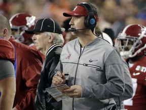 FILE - In this Jan. 9, 2017, file photo, Alabama offensive coordinator Steve Sarkisian is seen on the sidelines during the second half of the NCAA college football playoff championship game against Clemson, in Tampa, Fla. When Alabama switched offensive coordinators during last season's playoff, it had an in-house solution. The Crimson Tide's support staff included former Washington and Southern California head coach Steve Sarkisian, who took over the offense for the championship game.  Western Kentucky didn't have that luxury this season when offensive line coach Geoff Dart was diagnosed with brain tumors and underwent surgery to limit his availability. The Hilltoppers had to rely on tight ends coach Mike Mahaffey and graduate assistant Mike Bivin to pick up the slack.  Those two examples underscore the difference in staff sizes between Power Five programs and Group of Five schools.
