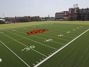 FILE - This Sept. 5, 2013, file photo shows one of the football practice fields at Oklahoma State University in Stillwater, Okla. Media rights deals and the College Football Playoff have increased revenue at all levels of the Football Bowl Subdivision, but the gap has grown between the Group of Five leagues and the Power Five conferences.