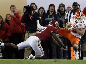 FILE- In this Jan. 10, 2017, file photo, Clemson's Hunter Renfrow, right, catches a touchdown pass in front of Alabama's Tony Brown during the second half of the NCAA college football playoff championship game in Tampa, Fla. Renfrow, a former walk-on, made the catch with 1 second left that gave Clemson a win over Alabama in the College Football Playoff championship game.