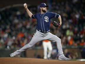 FILE - In this Sept. 29, 2017, file photo, San Diego Padres pitcher Jordan Lyles throws to the San Francisco Giants during the first inning of a baseball game, in San Francisco. Lyles and the Padres have agreed to a $1 million, one-year contract, Sunday, Dec. 17, 2017, that includes a club option for 2019.