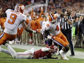 FILE - In this Jan. 9, 2017, file photo, Clemson's Deshaun Watson runs for a touchdown during the first half of the NCAA college football playoff championship game against Alabama in Tampa, Fla. With the Pac-12 and Big Ten not represented in the four-team College Football Playoff, a TV sports viewership analyst said interest could be tempered on the West Coast, upper Midwest and Northeast."I think it's too regional this year," said Jon Lewis, editor of Sports Media Watch. "That hurts in every sport–unless it's the Super Bowl." That said, Lewis expects a potential loss of viewership could be offset because the semifinals will be played on New Year's Day, the traditional college football holiday. The last two years the semifinals were on New Year's Eve, when the game competed with parties and other celebrations. An additional boost might come from the Alabama-Clemson semifinal in the Sugar Bowl being a rematch of the last two national championship games.