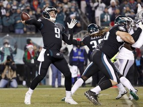 FILE - In this Dec. 25, 2017, file photo, Philadelphia Eagles' Nick Foles throws a pass during the first half of the team's NFL football game against the Oakland Raiders in Philadelphia. The Eagles have already lost several important players to injury, including MVP candidate Carson Wentz. They can't afford to lose backup quarterback Foles. But the offense struggled in the last game and Foles could use the reps with his receivers. Coach Doug Pederson is weighing the importance of protecting players from injury and keeping them sharp, as the team prepares to play the Dallas Cowboys this week.